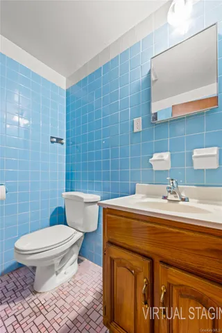 a bathroom with a sink a toilet and mirror