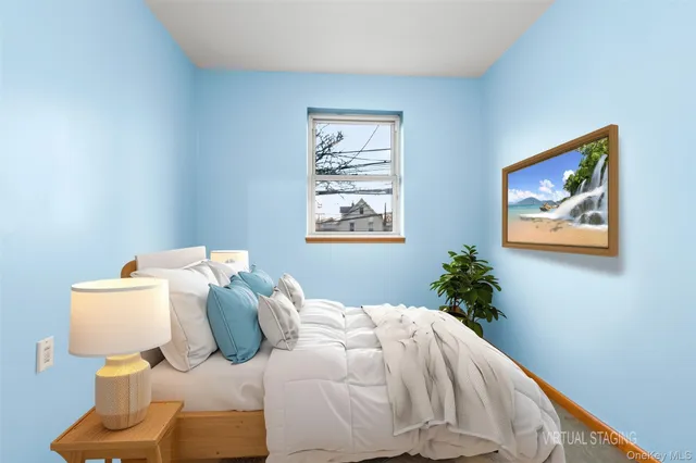 a bedroom with a bed and painting on the wall
