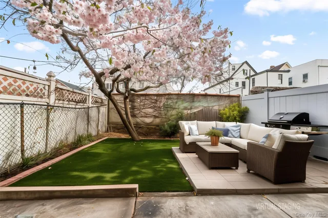 a backyard of a house with table and chairs