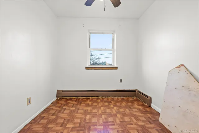 a view of a room with wooden floor and a window