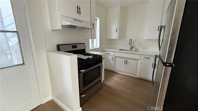 a kitchen with stainless steel appliances a refrigerator and a stove