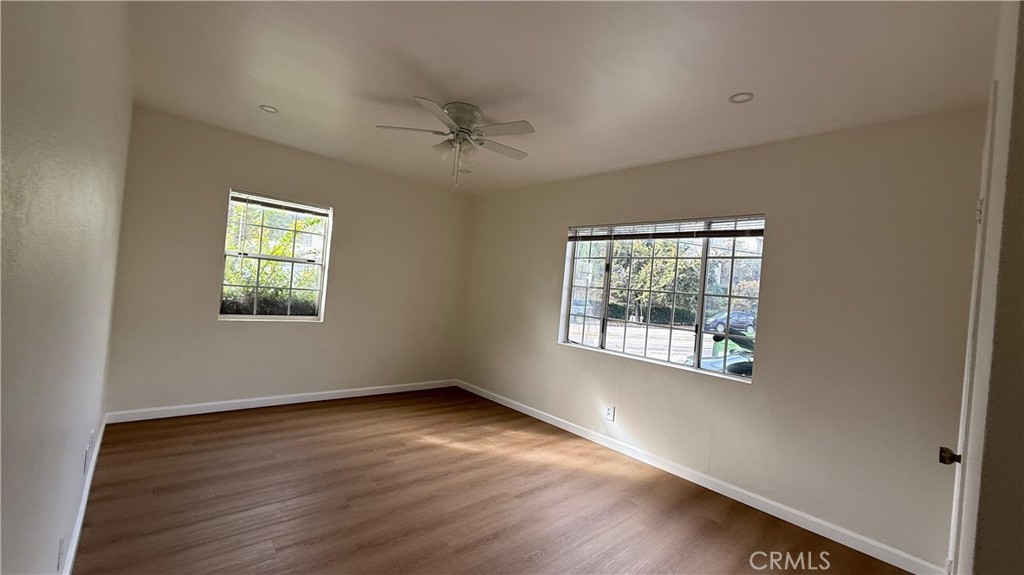 1345 Anaheim Street, Unit 2 Harbor City, CA 90710 - Photo 2 of 16 a view of an empty room with a window and wooden floor
