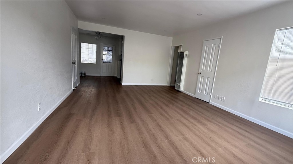 1345 Anaheim Street, Unit 2 Harbor City, CA 90710 - Photo 3 of 16 wooden floor in an empty room with a window