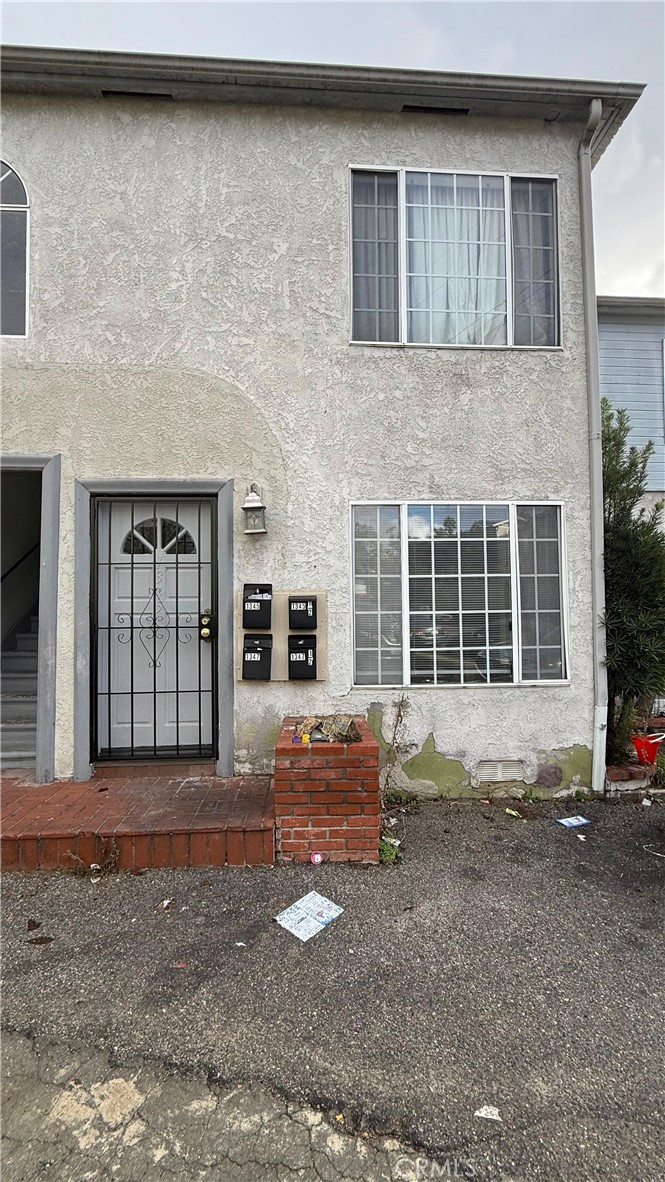 1345 Anaheim Street, Unit 2 Harbor City, CA 90710 - Photo 5 of 16 a front view of a house with a yard