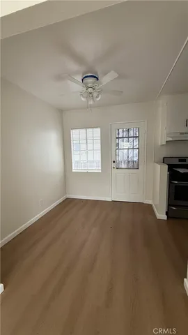 an empty room with windows and fireplace
