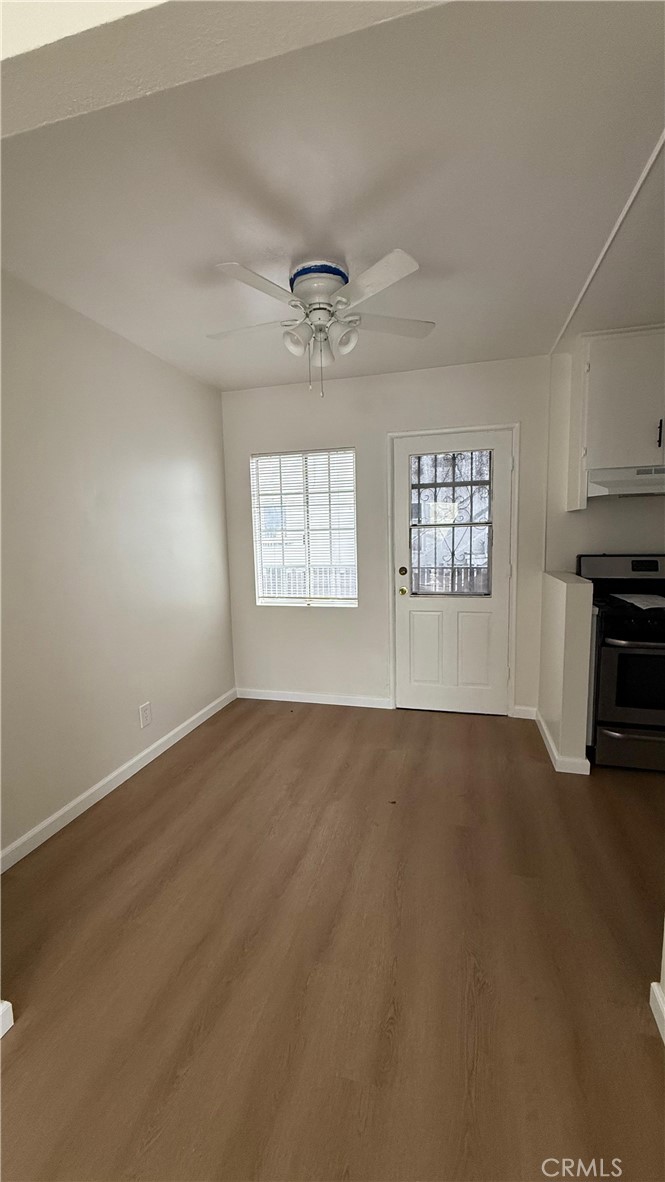 1345 Anaheim Street, Unit 2 Harbor City, CA 90710 - Photo 9 of 16 an empty room with windows and fireplace