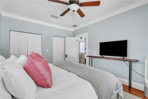 a bedroom with a bed and a flat screen tv