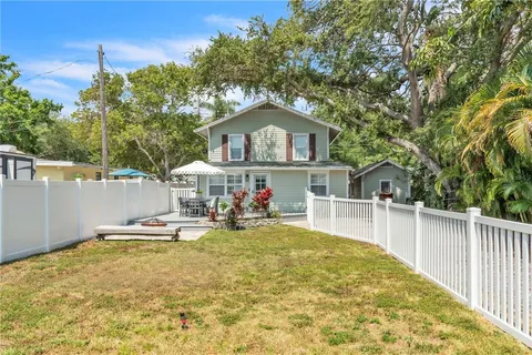 a view of a house with backyard and sitting area