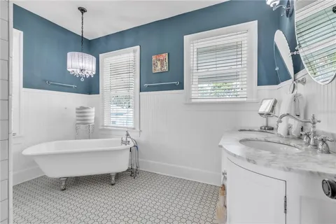 a spacious bathroom with a bathtub and a sink