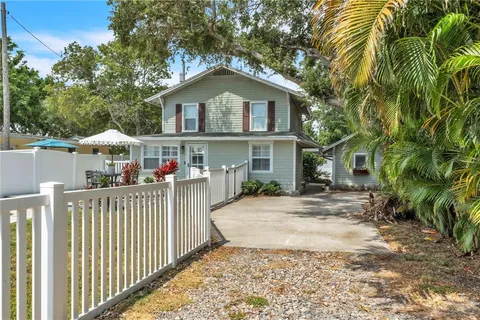a front view of house with wooden fence