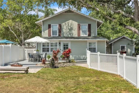 a front view of house with yard outdoor seating and barbeque oven