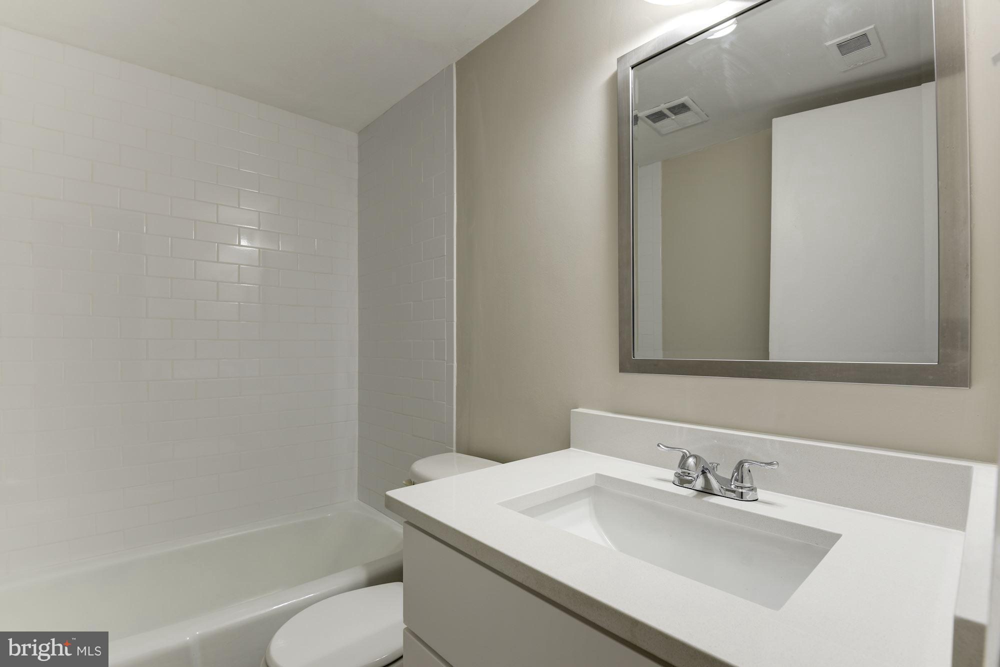 1538 Northgate Square, Unit 1A Reston, VA 20190 - Photo 15 of 18 a bathroom with a sink vanity mirror and toilet