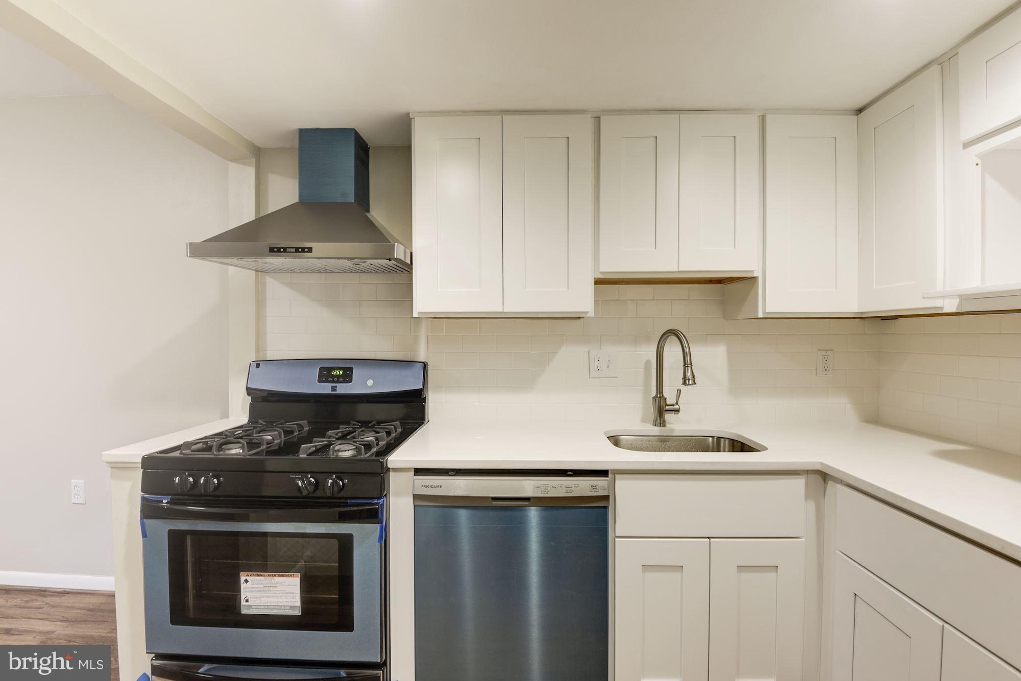 1538 Northgate Square, Unit 1A Reston, VA 20190 - Photo 3 of 18 a kitchen with a stove and a white cabinets
