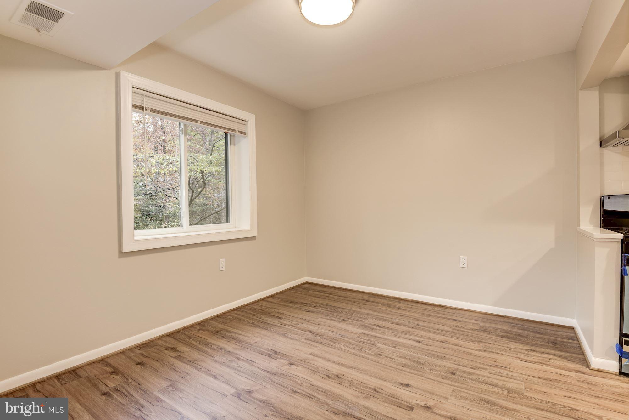 1538 Northgate Square, Unit 1A Reston, VA 20190 - Photo 7 of 18 an empty room with wooden floor and windows