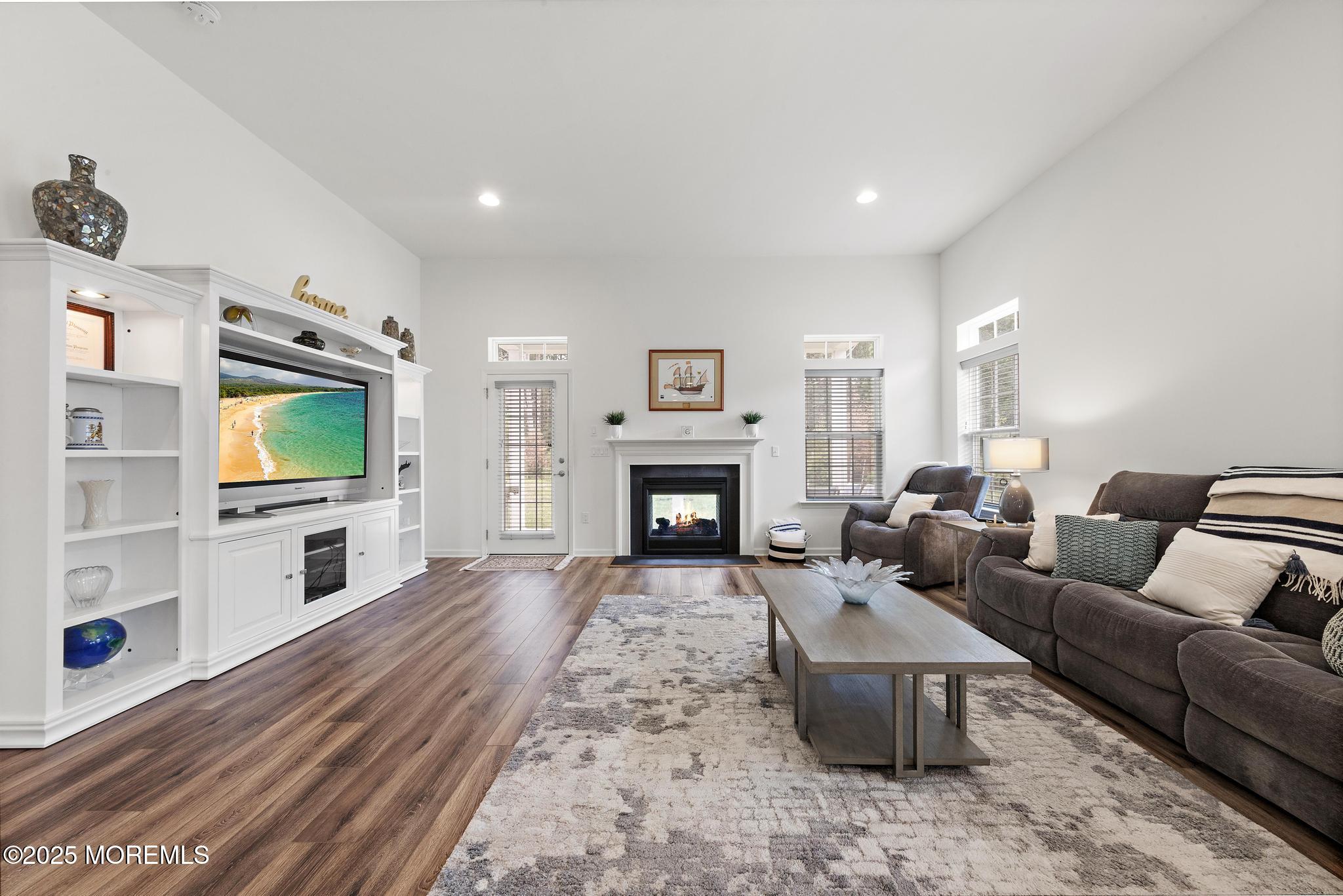 21 Aurora Circle Barnegat, NJ 08005 - Photo 18 of 79 a living room with furniture a flat screen tv and a fireplace