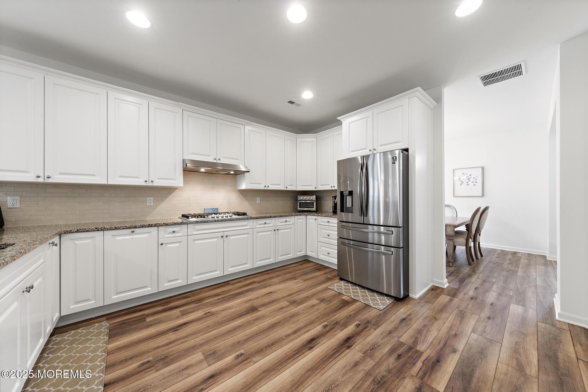 21 Aurora Circle Barnegat, NJ 08005 - Photo 28 of 79 a kitchen with granite countertop white cabinets and stainless steel appliances