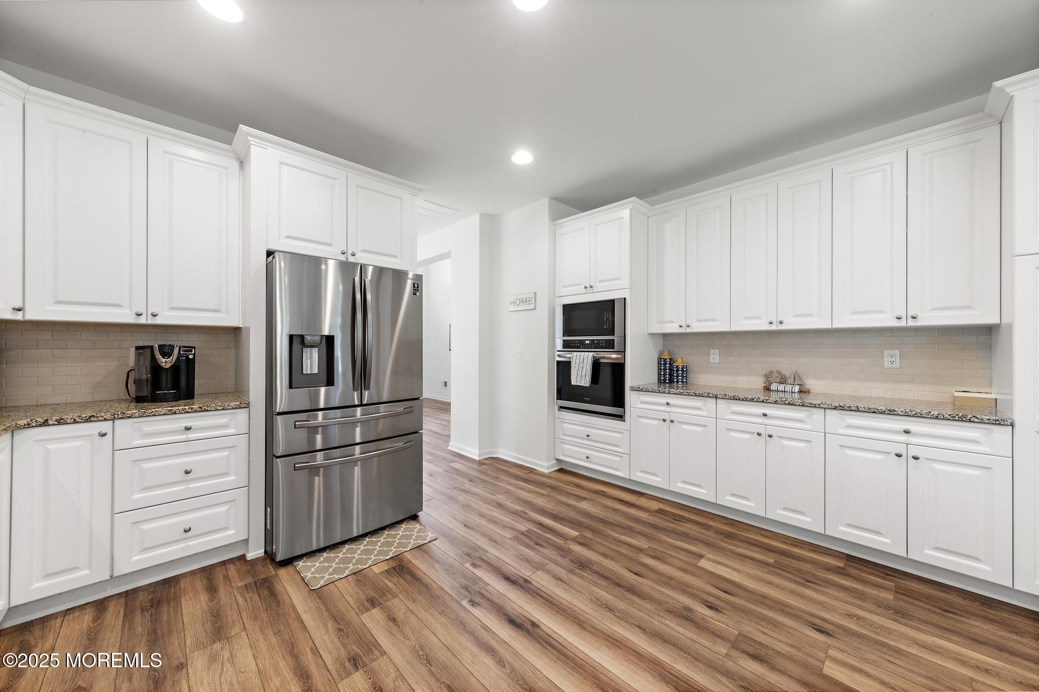 21 Aurora Circle Barnegat, NJ 08005 - Photo 33 of 79 a kitchen with granite countertop white cabinets and stainless steel appliances