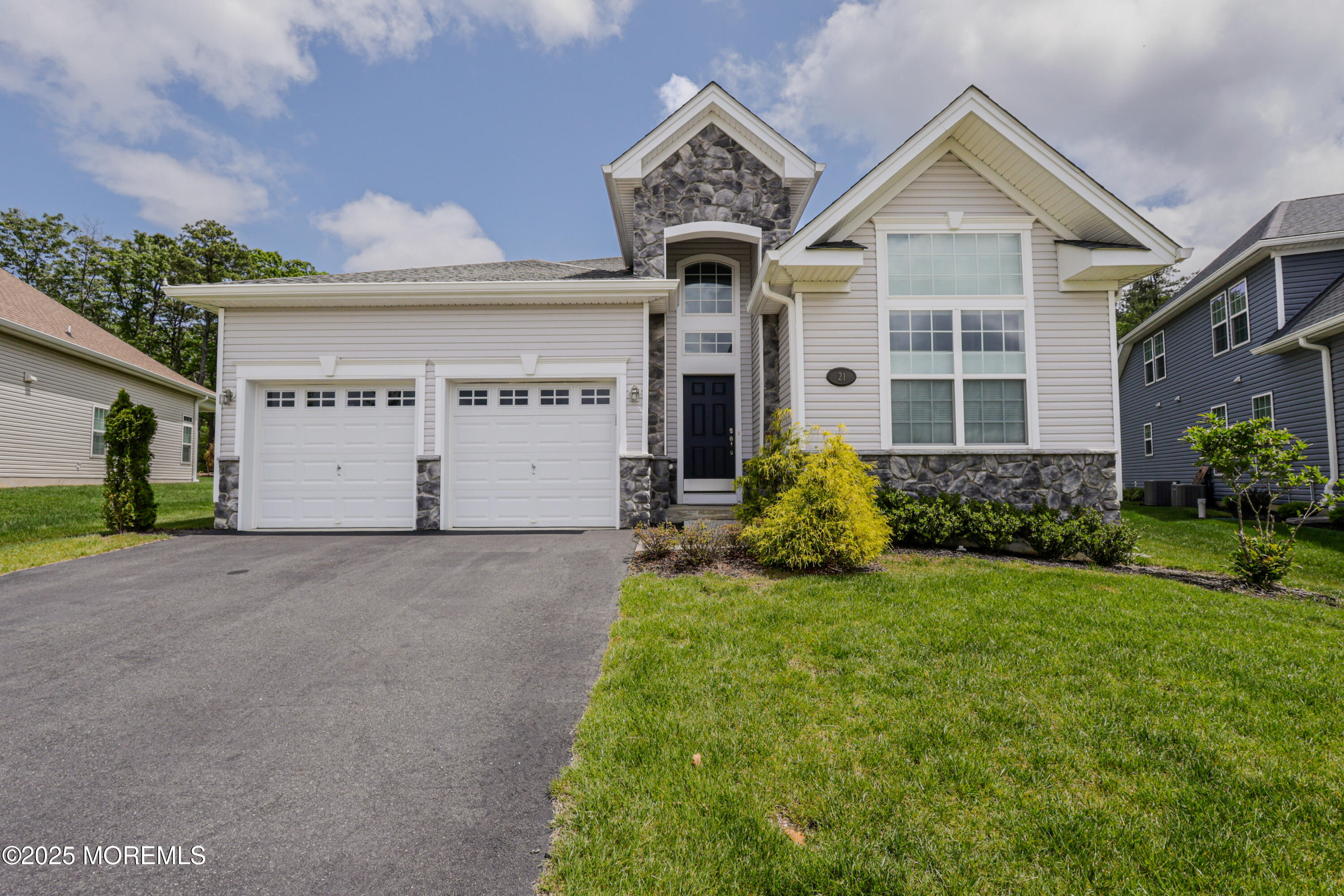 21 Aurora Circle Barnegat, NJ 08005 - Photo 4 of 79 a front view of a house with a yard and garage
