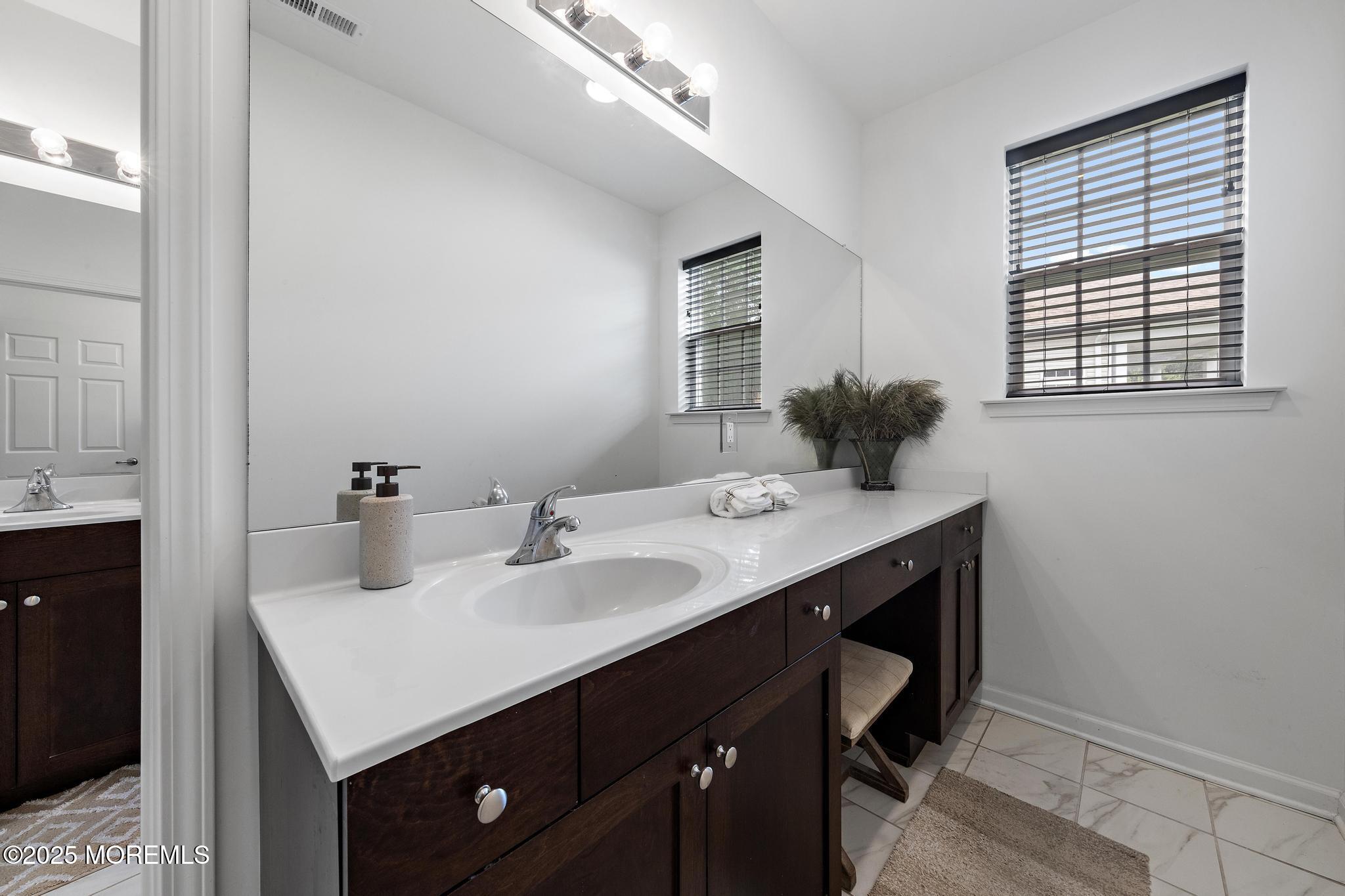 21 Aurora Circle Barnegat, NJ 08005 - Photo 48 of 79 a bathroom with a sink vanity and a mirror