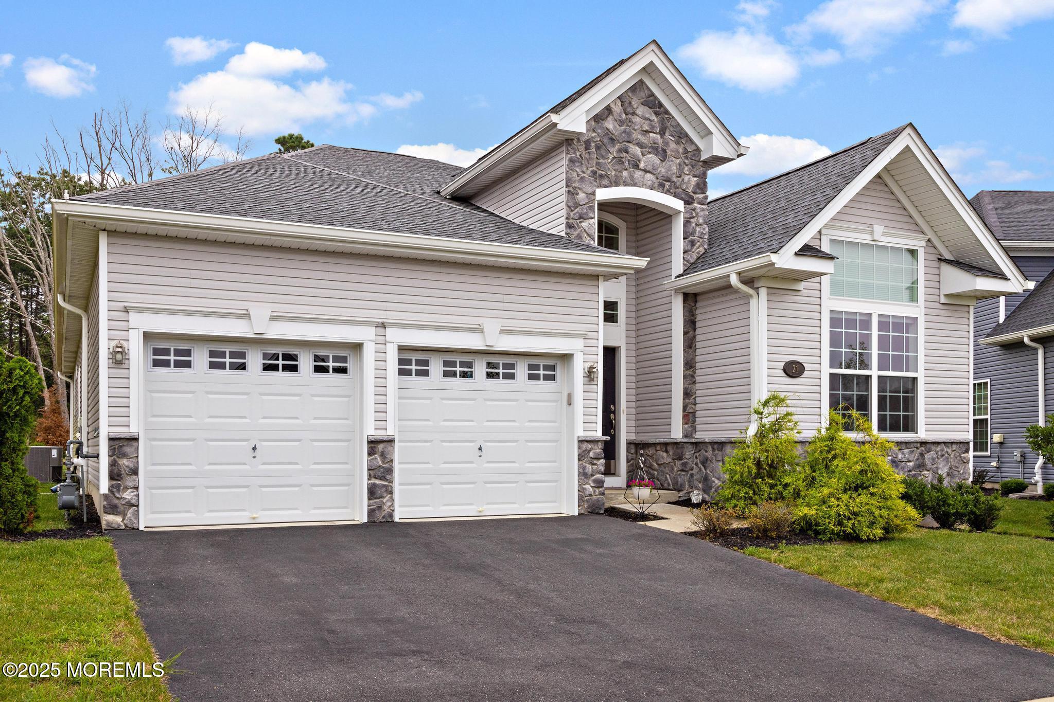 21 Aurora Circle Barnegat, NJ 08005 - Photo 5 of 79 a front view of a house with a yard and garage