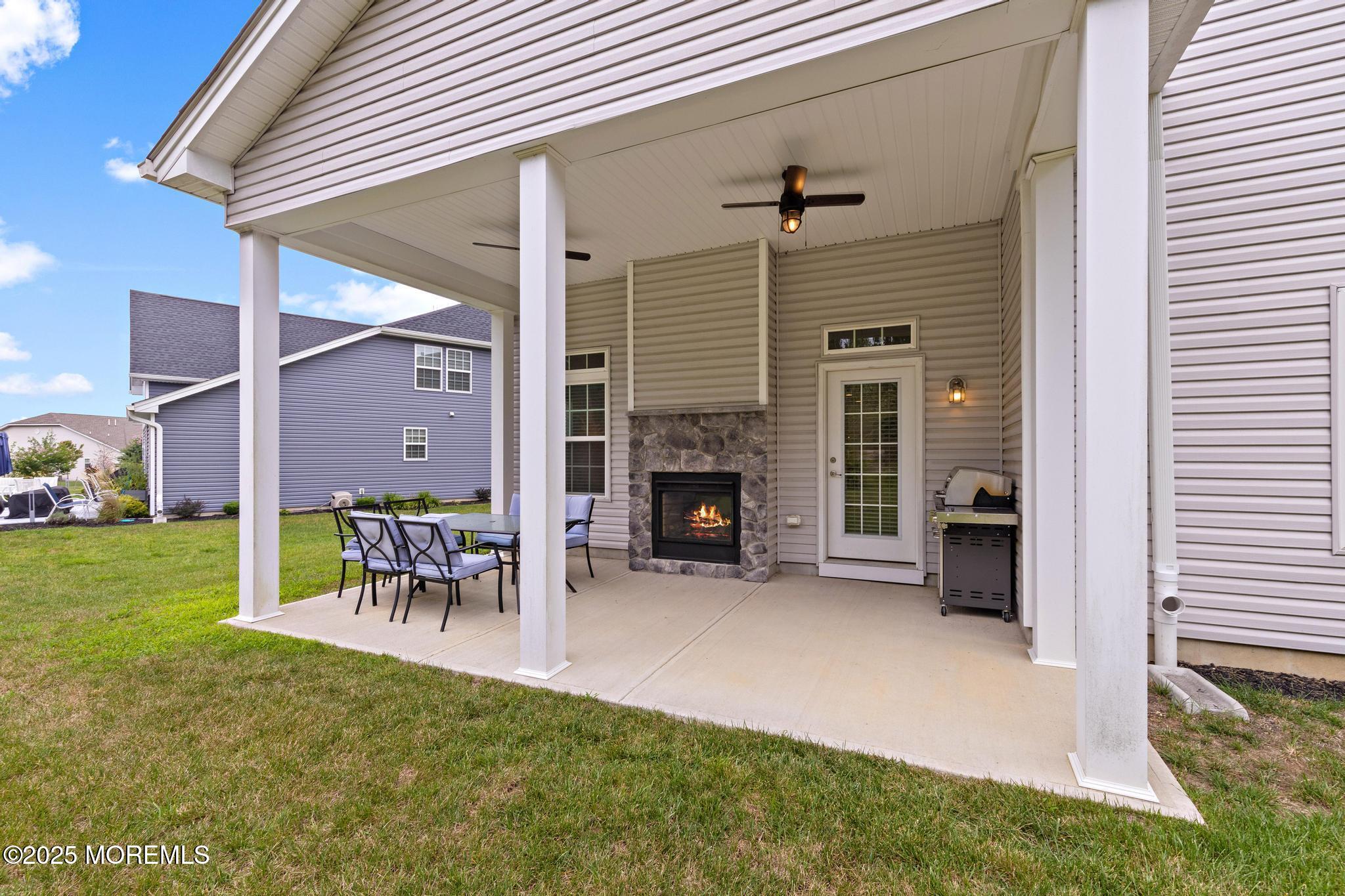21 Aurora Circle Barnegat, NJ 08005 - Photo 60 of 79 a view of a porch with a table and a fireplace