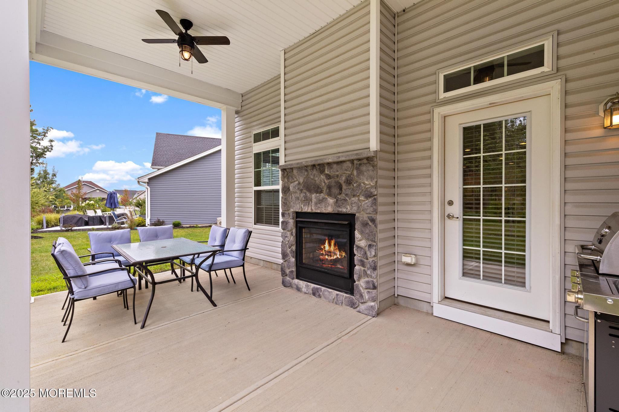 21 Aurora Circle Barnegat, NJ 08005 - Photo 61 of 79 a dining room with furniture and a fireplace