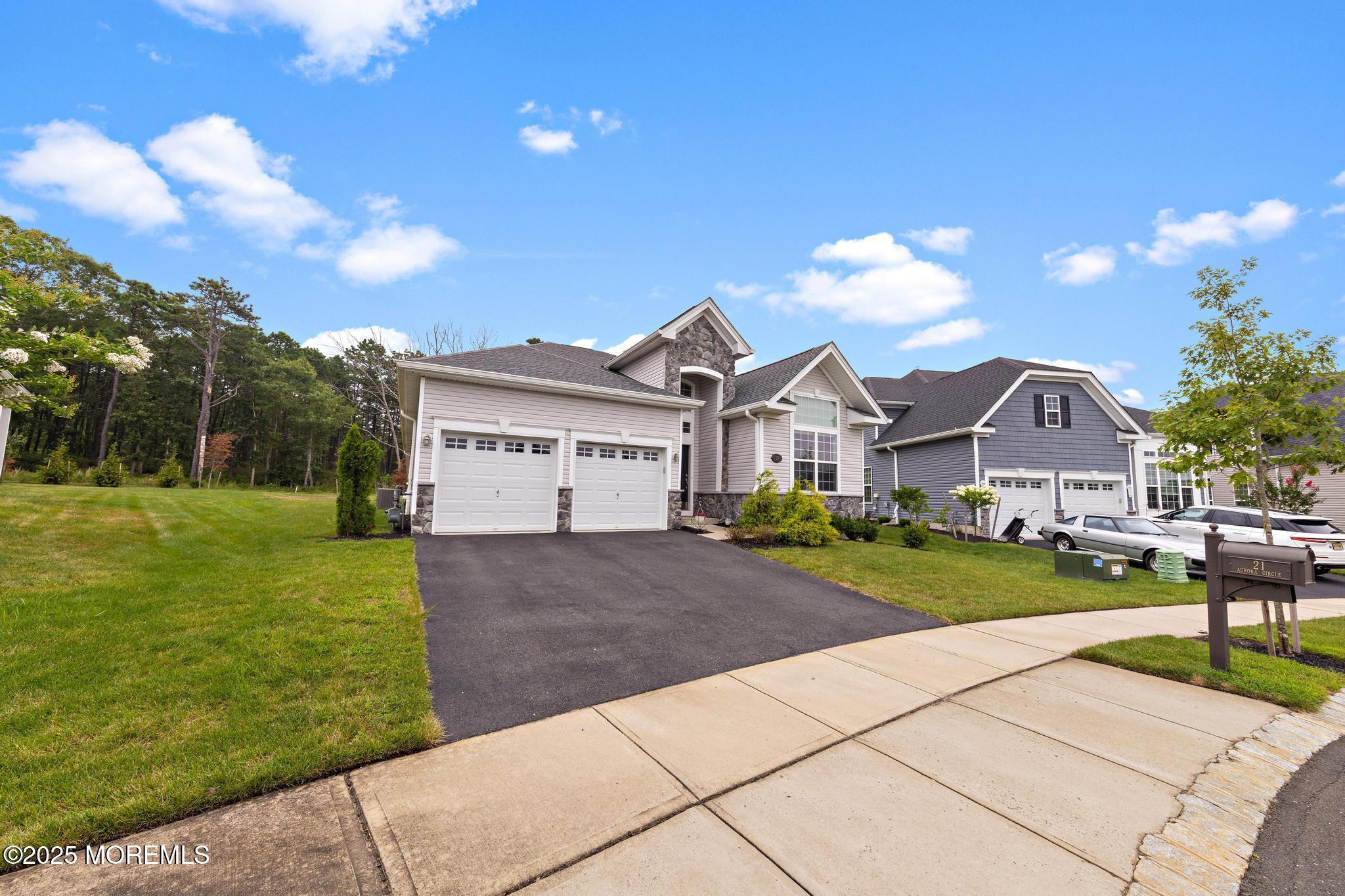 21 Aurora Circle Barnegat, NJ 08005 - Photo 8 of 79 a front view of a house with a yard and garage