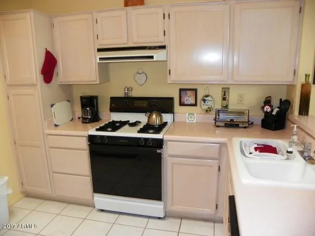 a bedroom with a bed and a lamp with the dresser