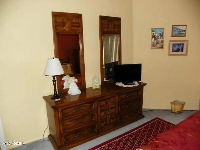 a bedroom with a bed and a television