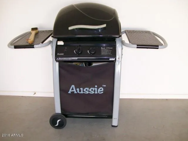 a view of a yard with plants and a bench
