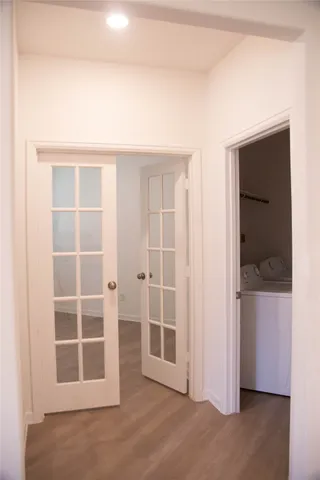 a view of a room with wooden floor and windows
