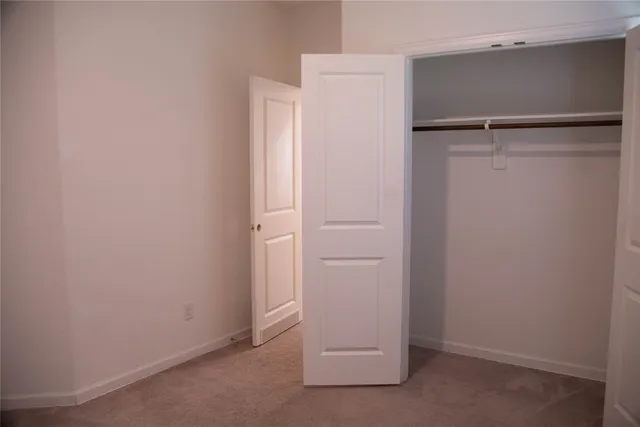 a view of a hallway with wooden floor and entryway