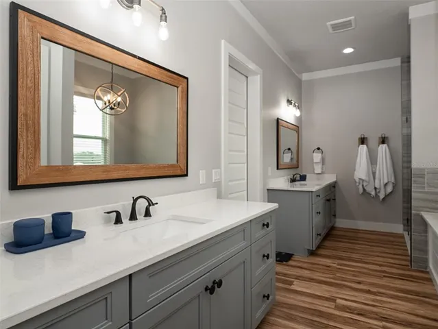 a bathroom with a double vanity sink and mirror