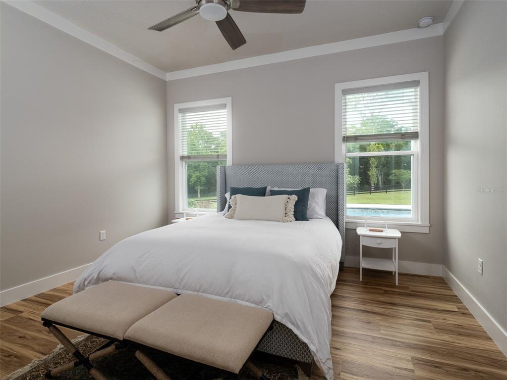 4988 Northwest 101st St Road Ocala, FL 34482 - Photo 15 of 30 a bedroom with a bed and wooden floor