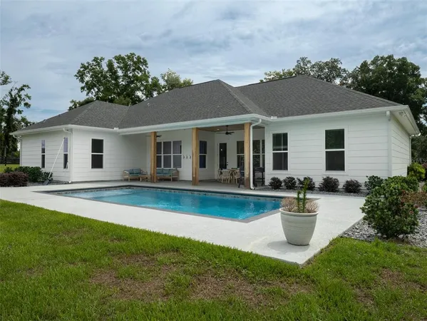 a view of a house with swimming pool yard and porch