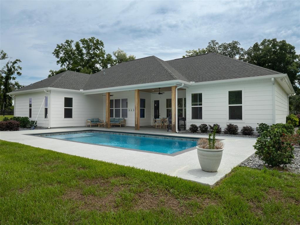 4988 Northwest 101st St Road Ocala, FL 34482 - Photo 20 of 30 a view of a house with swimming pool yard and porch