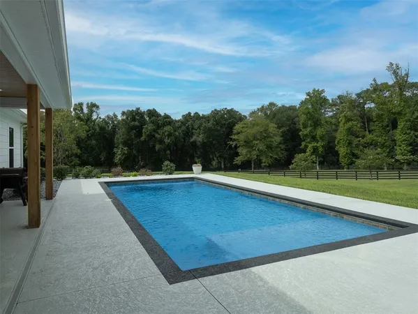 a view of swimming pool with a yard