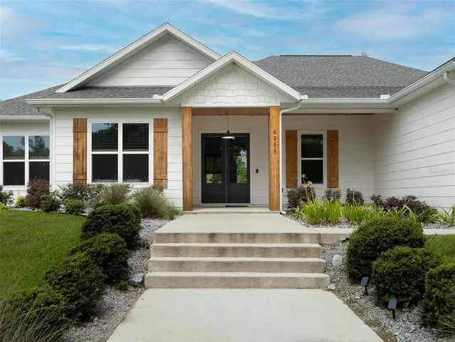 a front view of a house with a garden