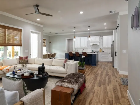 a living room with furniture and a wooden floor