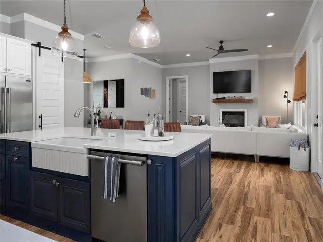 a kitchen with a sink stainless steel appliances and white cabinets