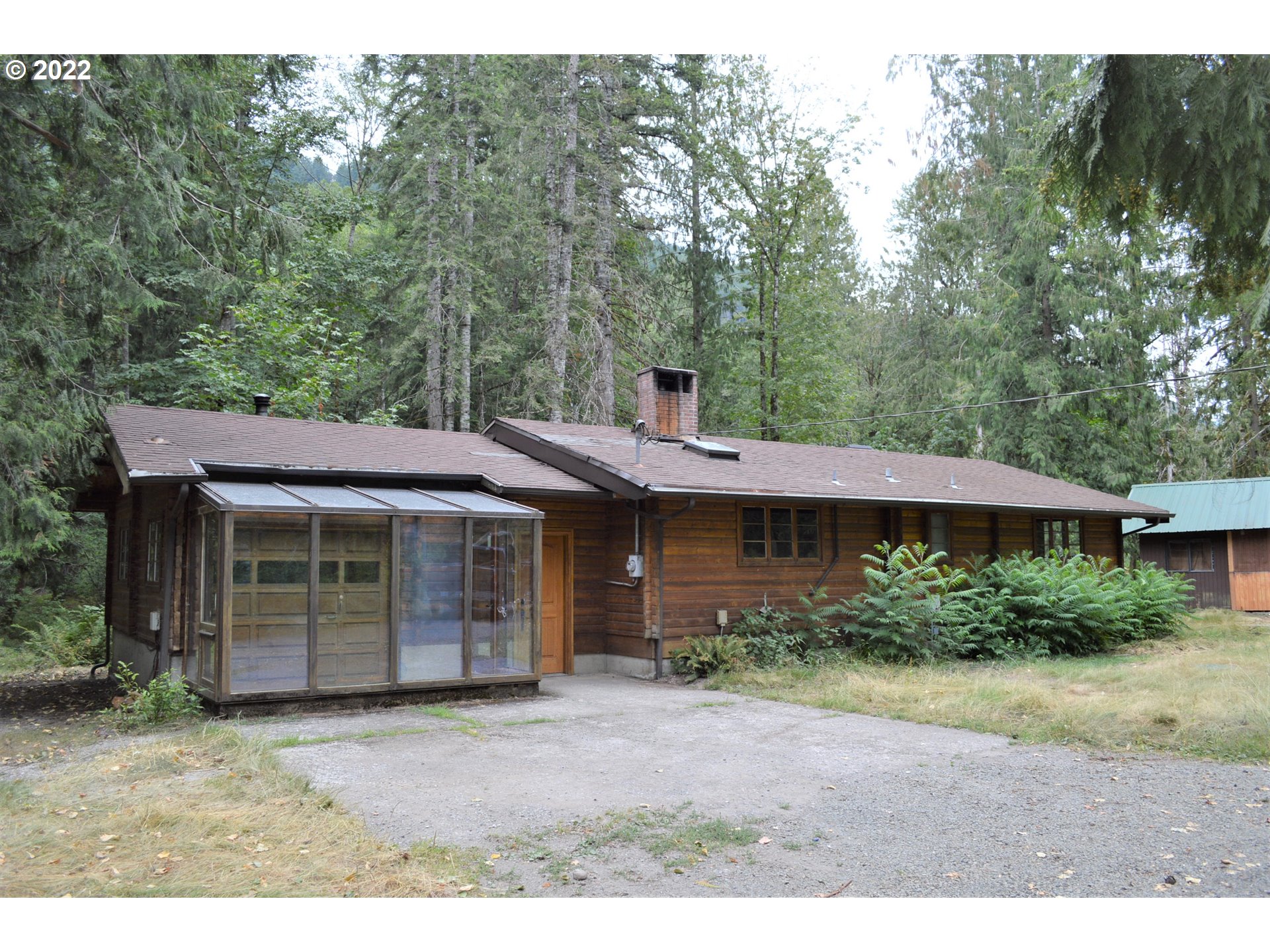 67193 East Barlow Trail Road Rhododendron, OR 97049 - Photo 2 of 19 a front view of a house with a garden