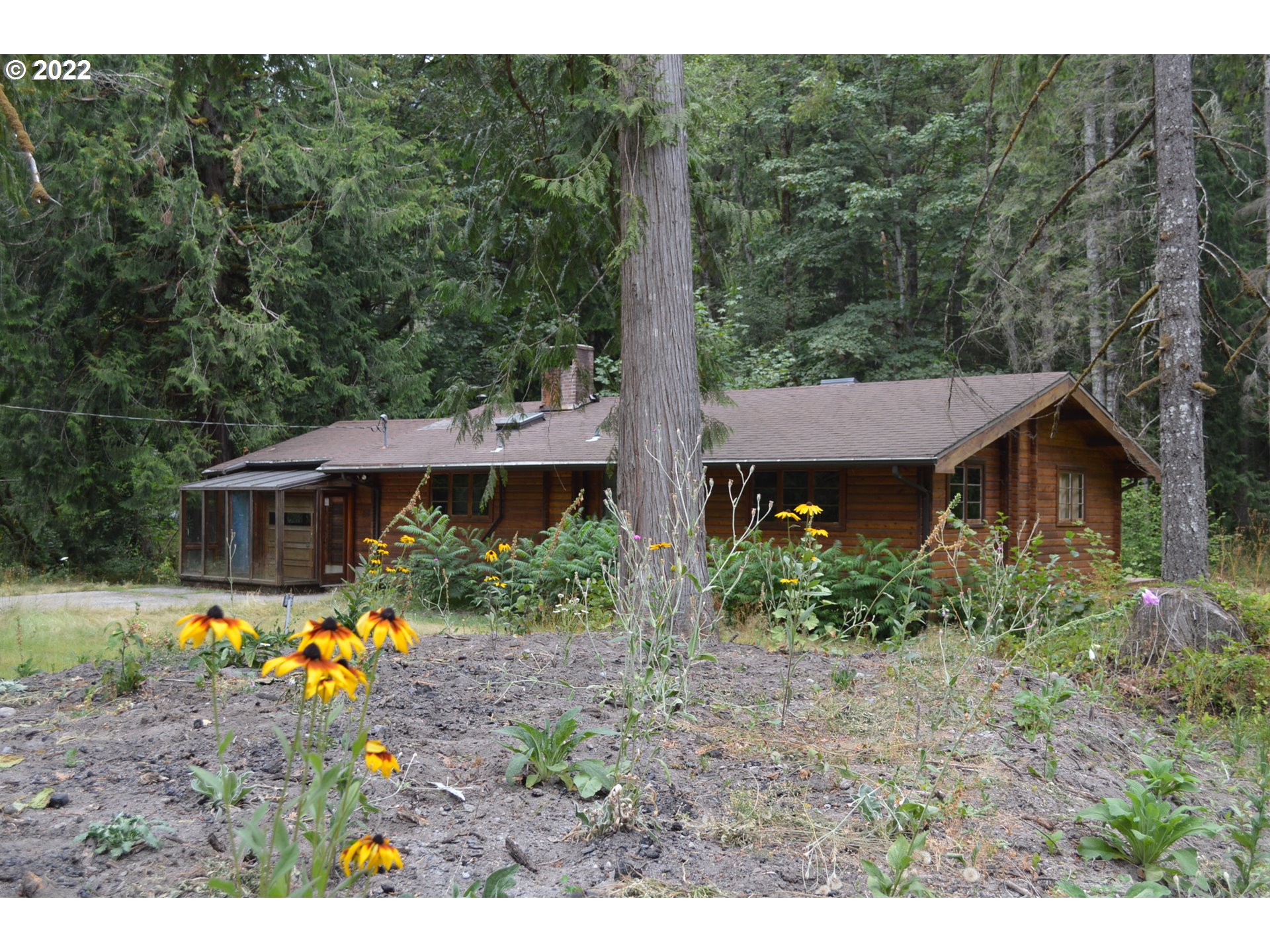 67193 East Barlow Trail Road Rhododendron, OR 97049 - Photo 4 of 19 a view of a house with a yard and garden