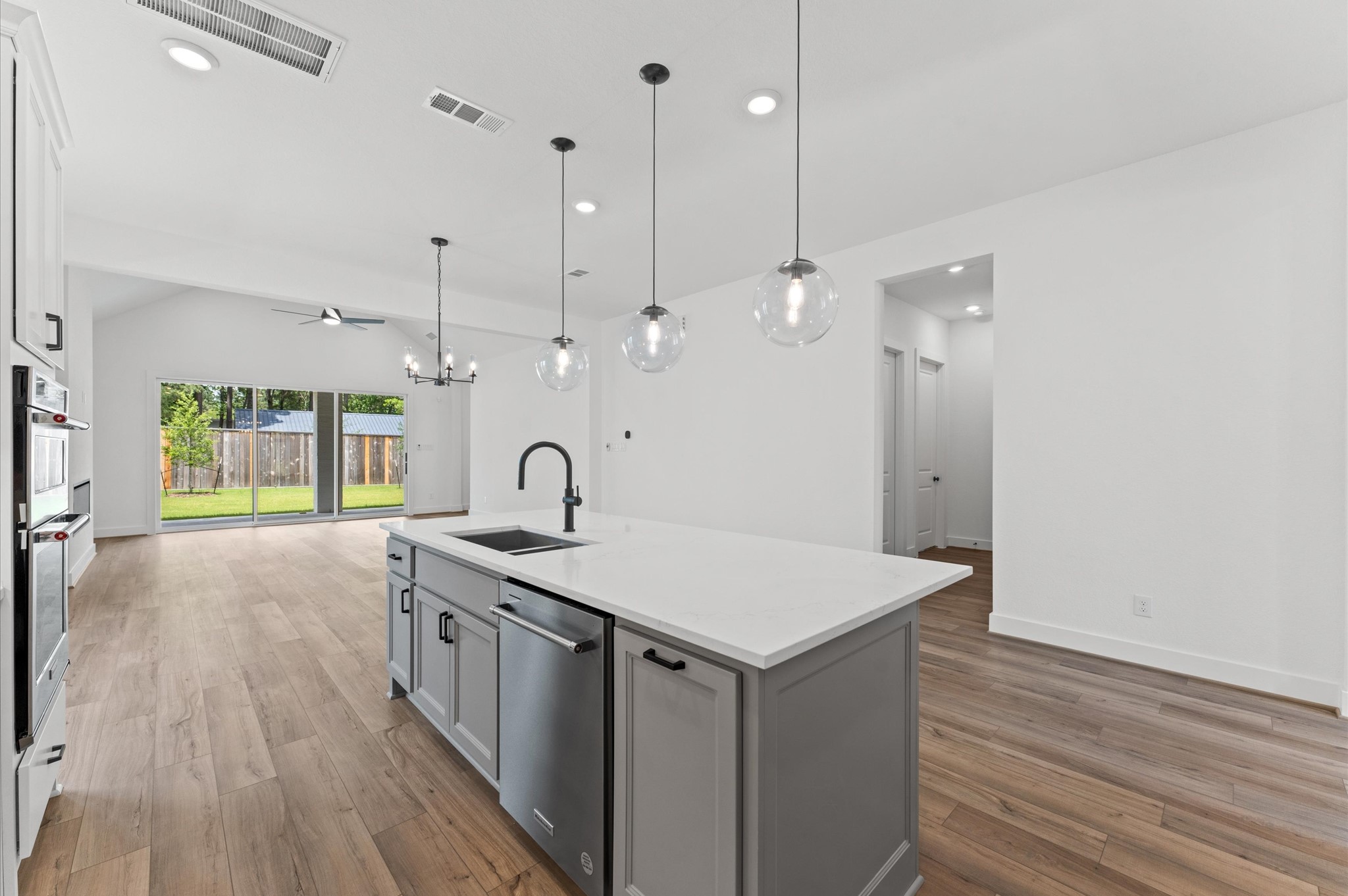 8218 Sherman Pk Trail Spring, TX 77389 - Photo 9 of 28 a kitchen with a sink a counter space and wooden floor