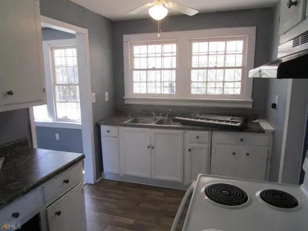 a kitchen with a refrigerator and a stove
