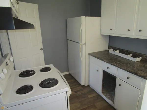 a kitchen with a refrigerator and a stove