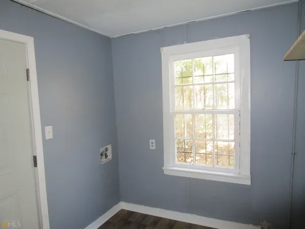 a bathroom with a granite countertop toilet and a sink