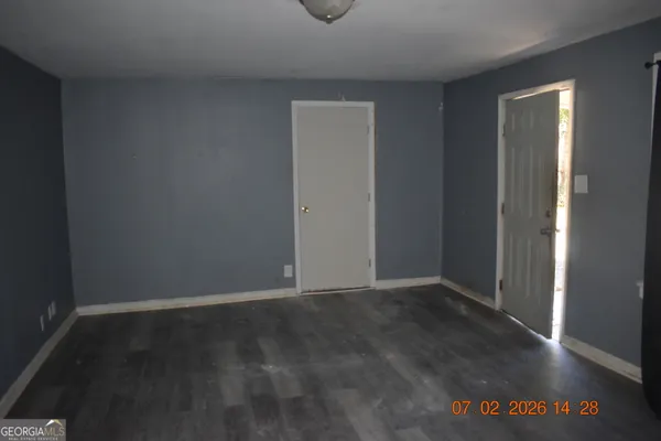 an empty room with wooden floor