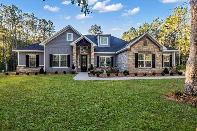 a front view of house with yard and green space