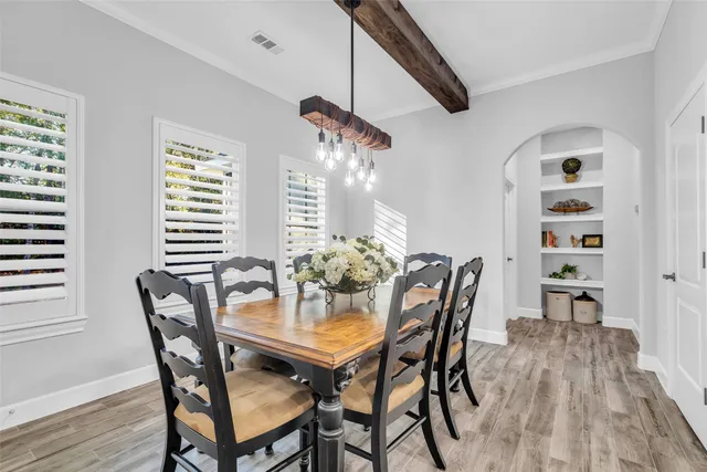 a dining room with furniture and window