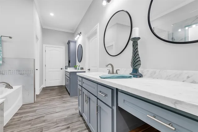 a bathroom with a double vanity sink and a mirror